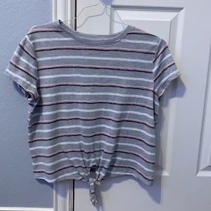 cute kids top with a tie at the bottom